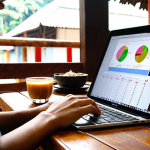 **

A person sitting at a cafe in Southeast Asia (e.g., Vietnam, Thailand) working on a laptop, with a budget planning app or spreadsheet visible on the screen. Focus on a bright, motivated look, showcasing the digital nomad lifestyle but also highlighting the importance of budgeting. Maybe include a local coffee or snack on the table.

**